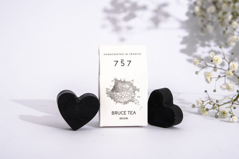 Two little cute hart shaped black soaps made of charcoal and tea tree essential oil.
